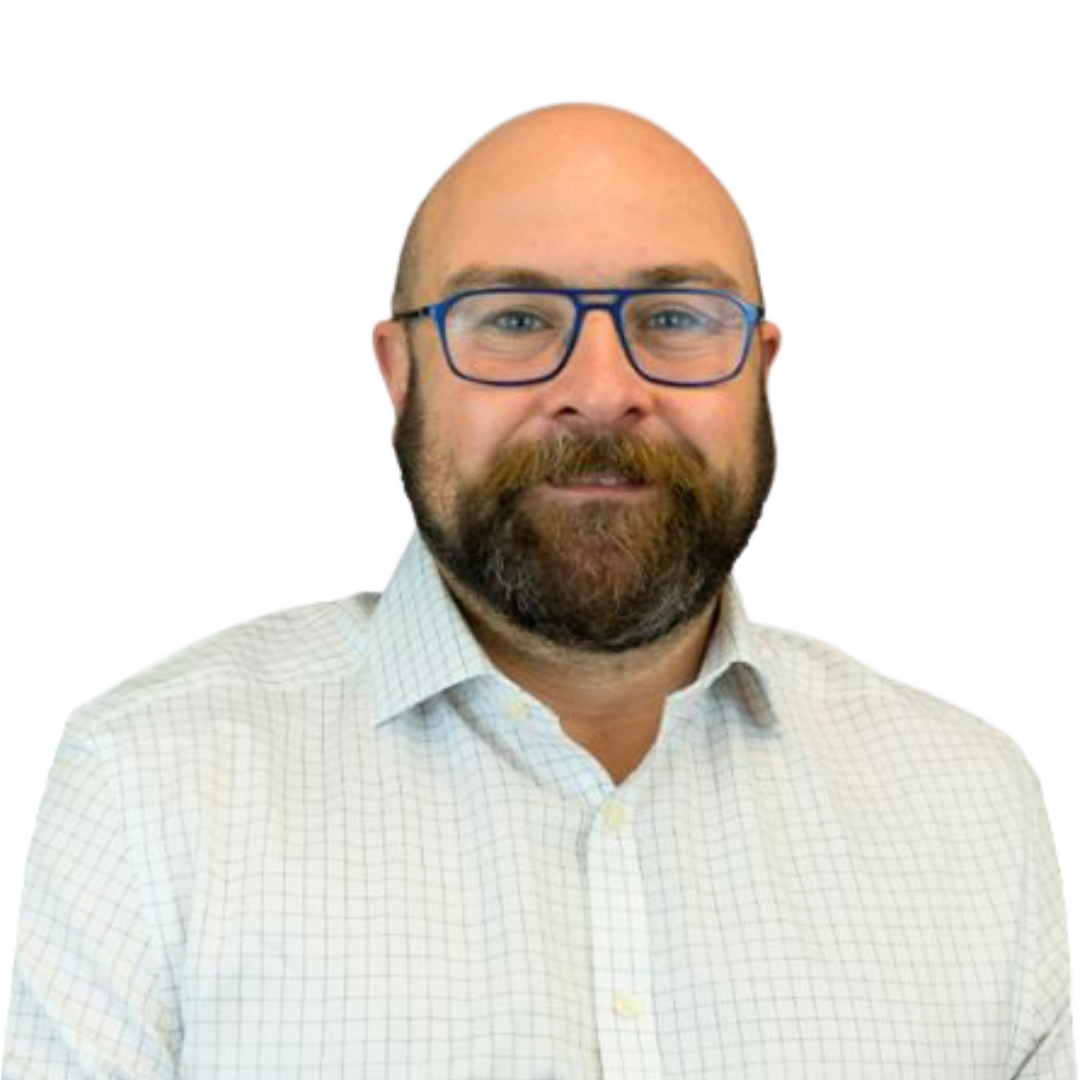 A smiling man with a beard and glasses wearing a light checkered shirt, against a transparent background.